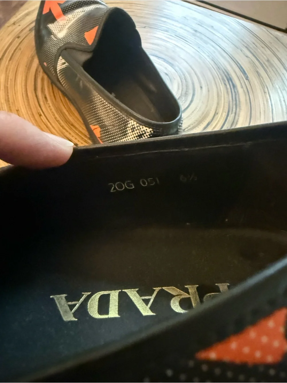 Prada Black Leather Slip-On Loafers with Orange Arrow Motif
